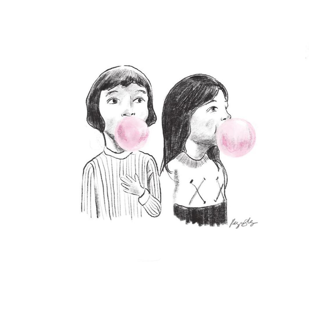 Two friends blowing pink bubblegum bubbles